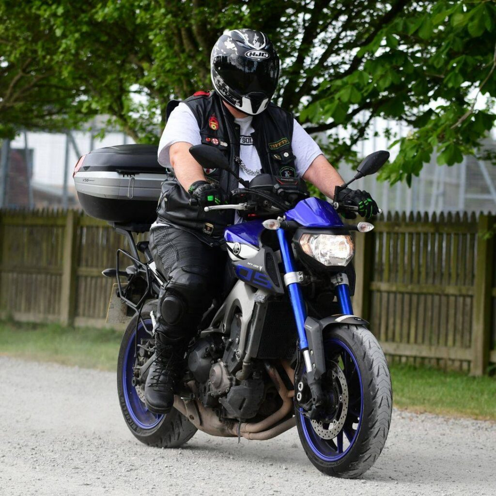 Me! Riding a blue Yamaha MT09 arriving at a motorbike rally.
